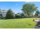 Beautifully maintained backyard with green lawn, mature trees, and a quaint garden border at 11866 Weathered Edge Dr, Fishers, IN 46037