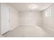 Finished basement with neutral carpet, a door, and a window to the outside at 11866 Weathered Edge Dr, Fishers, IN 46037