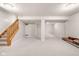 Finished basement with neutral carpet, ample space, and a staircase leading to the upper levels at 11866 Weathered Edge Dr, Fishers, IN 46037