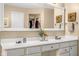 Bathroom features dual sinks, a large mirror, and decorative fixtures at 11866 Weathered Edge Dr, Fishers, IN 46037