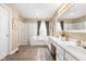 This spacious bathroom features double sinks, a soaking tub, walk-in shower, and neutral tones at 11866 Weathered Edge Dr, Fishers, IN 46037