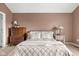 Bedroom featuring a comfortable bed, dresser, and a warm color scheme at 11866 Weathered Edge Dr, Fishers, IN 46037