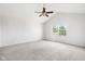 Spacious bedroom featuring neutral carpet, ceiling fan, and a bright window offering natural light at 11866 Weathered Edge Dr, Fishers, IN 46037
