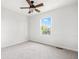 Bright, carpeted bedroom with a ceiling fan and a view of the neighborhood at 11866 Weathered Edge Dr, Fishers, IN 46037