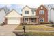 Charming two-story home with a brick and siding exterior, attached garage, and well-manicured front lawn at 11866 Weathered Edge Dr, Fishers, IN 46037