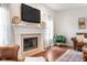 Cozy living room with a fireplace, mounted television, and large windows with sheer curtains at 11866 Weathered Edge Dr, Fishers, IN 46037