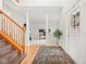 Open foyer featuring hardwood floors, staircase, and pillars leading into the living space, offering a grand entrance at 11866 Weathered Edge Dr, Fishers, IN 46037