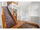 Spacious foyer features hardwood floors, a staircase with wood railings, and elegant columns leading to the living area at 11866 Weathered Edge Dr, Fishers, IN 46037