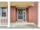 Inviting front door with wreath and sidelights, set in a brick facade with a covered porch at 11866 Weathered Edge Dr, Fishers, IN 46037