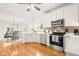 Charming kitchen with stainless steel appliances, white cabinets, and open dining area nearby at 11866 Weathered Edge Dr, Fishers, IN 46037