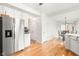 Well-equipped kitchen with stainless steel refrigerator, white cabinets, and an adjacent dining area at 11866 Weathered Edge Dr, Fishers, IN 46037