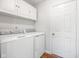Functional laundry area with modern washer and dryer, plus overhead storage at 11866 Weathered Edge Dr, Fishers, IN 46037