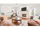 Comfortable living room with a fireplace, hardwood floors, and bright windows at 11866 Weathered Edge Dr, Fishers, IN 46037