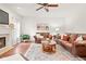 Spacious living room featuring hardwood floors, comfortable seating, and a warm fireplace, perfect for relaxation at 11866 Weathered Edge Dr, Fishers, IN 46037