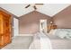 This main bedroom features a vaulted ceiling, neutral carpet, ceiling fan, and ensuite access at 11866 Weathered Edge Dr, Fishers, IN 46037