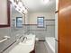 Well-lit bathroom featuring a combination tub and shower and ample vanity space at 1221 Kessler Blvd E Dr, Indianapolis, IN 46220