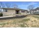 Charming single-story home with stone facade, well-manicured front yard and minimalist landscaping at 1221 Kessler Blvd E Dr, Indianapolis, IN 46220