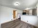 Bright kitchen with stainless steel appliances, warm wood cabinets, and hardwood flooring at 1221 Kessler Blvd E Dr, Indianapolis, IN 46220