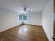 Spacious main bedroom with hardwood floors, ceiling fan, and natural light from two windows at 1221 Kessler Blvd E Dr, Indianapolis, IN 46220