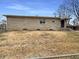 View of the home's rear exterior, highlighting the stone facade and backyard space at 1221 Kessler Blvd E Dr, Indianapolis, IN 46220