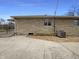 Side exterior with stone siding and a concrete driveway at 1221 Kessler Blvd E Dr, Indianapolis, IN 46220