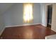 Bright bedroom featuring a window and hardwood floors at 1228 E Perry St, Indianapolis, IN 46227
