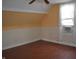 Cozy bedroom with sloped ceilings, floral wallpaper and window unit at 1228 E Perry St, Indianapolis, IN 46227