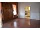 Inviting living room with hardwood floors leading to a kitchen area featuring vintage cabinetry at 1228 E Perry St, Indianapolis, IN 46227