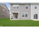 Photo of the backyard features a green lawn, and siding of the townhome at 1231 Langham St, Avon, IN 46123