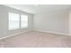 Bright bedroom features neutral walls, plush carpeting, and two windows for natural light at 1231 Langham St, Avon, IN 46123