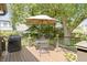 Inviting back deck featuring a patio table, chairs, and a grill perfect for outdoor relaxation at 14 Kessler Blvd W Dr, Indianapolis, IN 46208