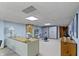 Finished basement area featuring a desk, exercise bike, and cabinet storage at 14 Kessler Blvd W Dr, Indianapolis, IN 46208