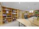 Finished basement with custom built-in bookshelves, a large desk, and recessed lighting at 14 Kessler Blvd W Dr, Indianapolis, IN 46208