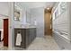Elegant bathroom with double vanity, marble floors, and tiled shower at 14 Kessler Blvd W Dr, Indianapolis, IN 46208