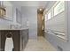 Stylish bathroom featuring double sinks, updated fixtures, and a glass shower at 14 Kessler Blvd W Dr, Indianapolis, IN 46208