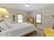 Comfortable bedroom with natural light, hardwood floors, and white comforter at 14 Kessler Blvd W Dr, Indianapolis, IN 46208