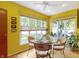 Sunny breakfast nook featuring a glass table and wicker chairs with large windows overlooking the greenery at 14 Kessler Blvd W Dr, Indianapolis, IN 46208
