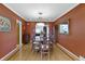 Charming dining room with wood floors and table, crown molding, with view to living room and backyard at 14 Kessler Blvd W Dr, Indianapolis, IN 46208