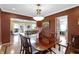Inviting dining room with wood table, decorative lighting, and rich, red walls creating a warm ambiance at 14 Kessler Blvd W Dr, Indianapolis, IN 46208