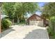 Spacious two-car garage with a long driveway, surrounded by trees and well-maintained landscaping at 14 Kessler Blvd W Dr, Indianapolis, IN 46208