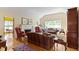 Cozy living room with hardwood floors, fireplace, and large window providing plenty of natural light at 14 Kessler Blvd W Dr, Indianapolis, IN 46208