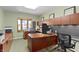 Functional office with built-in shelving, desk, large bay window, and neutral carpet at 14 Kessler Blvd W Dr, Indianapolis, IN 46208