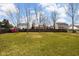 Spacious backyard with lush green grass, bordered by a wooden fence, providing ample space for recreation at 1657 10Th St, Danville, IN 46122