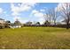 Large, grassy backyard features play set and mature trees, offering a serene and spacious outdoor environment at 1657 10Th St, Danville, IN 46122