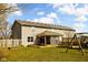 Spacious backyard featuring a covered patio and a play set, ideal for outdoor entertaining and Gathering fun at 1657 10Th St, Danville, IN 46122