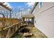 Home's backyard includes a covered patio, a bridge over a rock water feature, and views of the home's exterior at 1657 10Th St, Danville, IN 46122