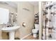 Charming bathroom with a pedestal sink, decorative shower curtain, and updated fixtures at 1657 10Th St, Danville, IN 46122