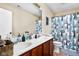 Bathroom featuring a double sink vanity with wood cabinets, a large mirror, and a shower/tub combo at 1657 10Th St, Danville, IN 46122