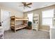 Bedroom featuring a wooden bunk bed, a ceiling fan, and natural light from two windows at 1657 10Th St, Danville, IN 46122