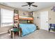 Cozy bedroom featuring a wooden bunk bed, ceiling fan, and natural light from the window at 1657 10Th St, Danville, IN 46122